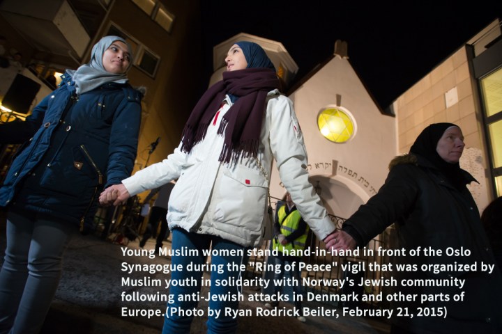 Young Muslim women stand hand-in-hand in front of the Oslo Synagogue during the "Ring of Peace" vigil, February 21, 2015. The vigil was organized by Muslim youth in solidarity with Norway's Jewish community following anti-Jewish attacks in Denmark and other parts of Europe.